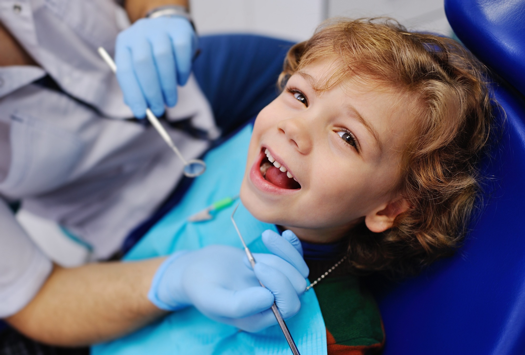 little girl smiling in dental chair